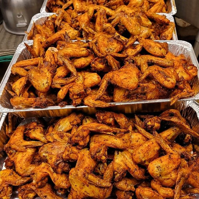 Eye-level view of seasoned baked wings arranged on a platter